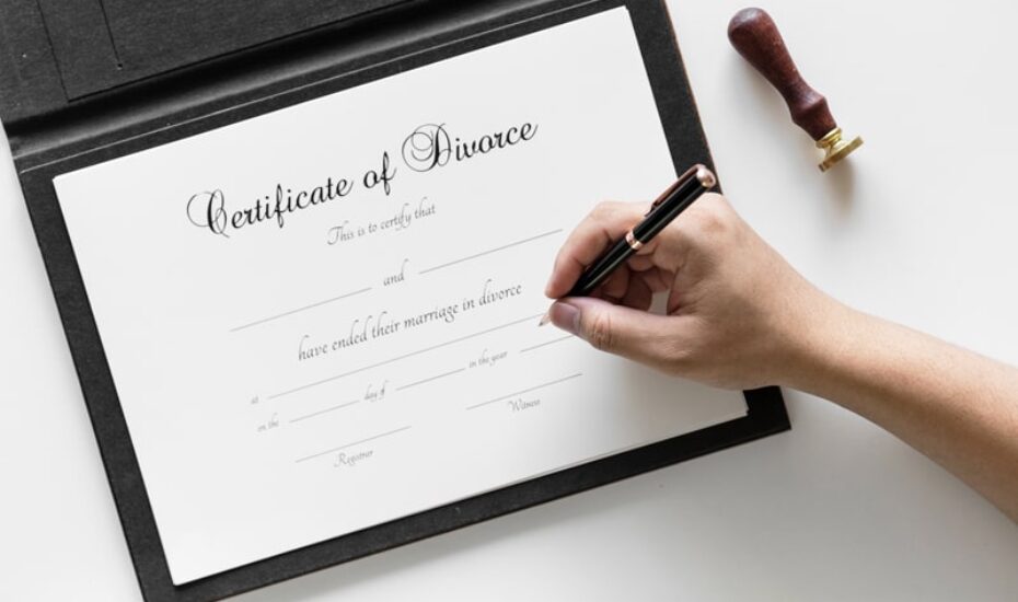Image of a lady signing a divorce certificate